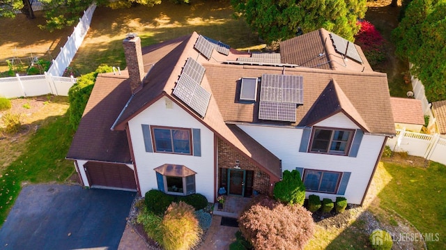 view of front facade with solar panels and a garage