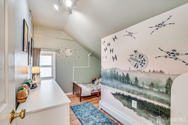 bedroom featuring light hardwood / wood-style flooring, vaulted ceiling, and a baseboard radiator