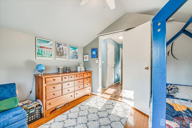 bedroom featuring ceiling fan, vaulted ceiling, and light wood-type flooring