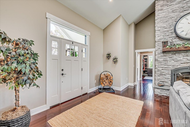 28 Evans Dr, Cranbury, NJ 08512 - entryway featuring high vaulted ceiling, dark wood-style flooring, baseboards, and a stone fireplace