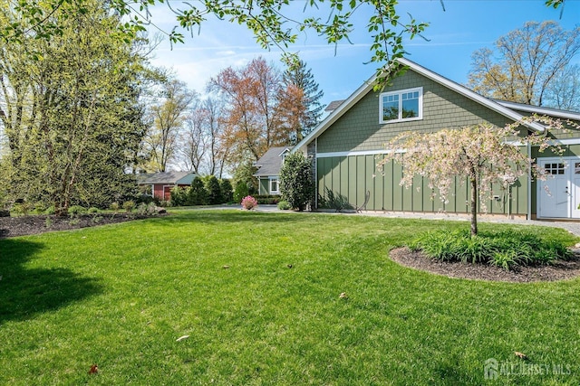 28 Evans Dr, Cranbury, NJ 08512 - view of property exterior featuring a lawn and board and batten siding