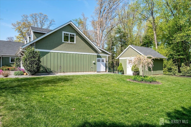 28 Evans Dr, Cranbury, NJ 08512 - view of front of home with an outdoor structure, a front yard, and board and batten siding