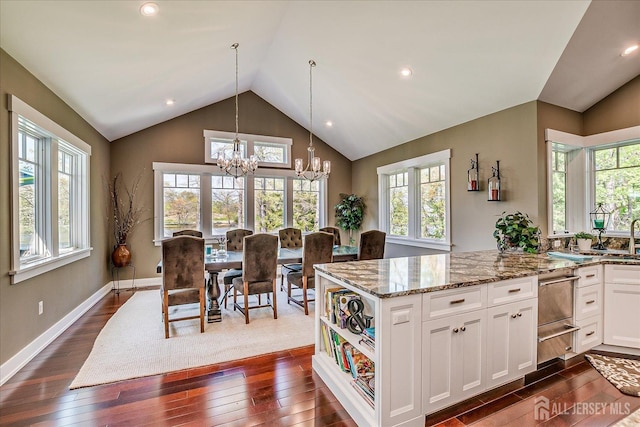 28 Evans Dr, Cranbury, NJ 08512 - kitchen with a chandelier, lofted ceiling, light stone counters, dark wood-style floors, and white cabinets