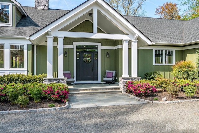 28 Evans Dr, Cranbury, NJ 08512 - doorway to property with board and batten siding, roof with shingles, a chimney, and a porch