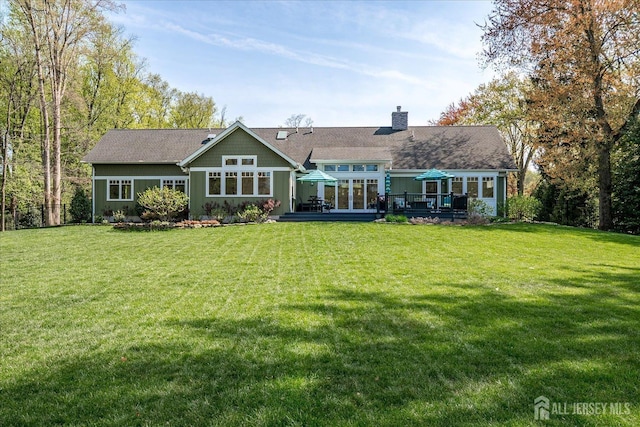 28 Evans Dr, Cranbury, NJ 08512 - back of house with a wooden deck, a chimney, and a lawn