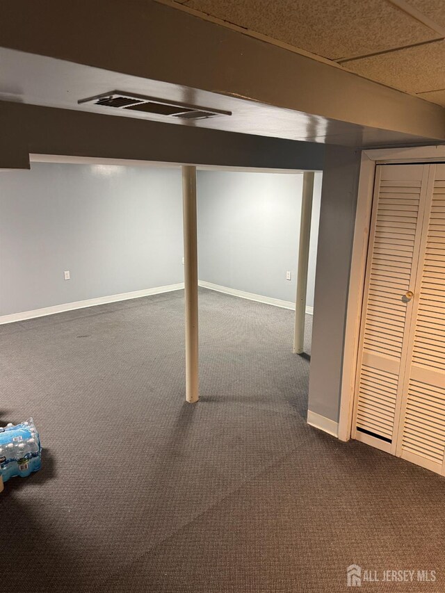 basement with carpet floors and a drop ceiling