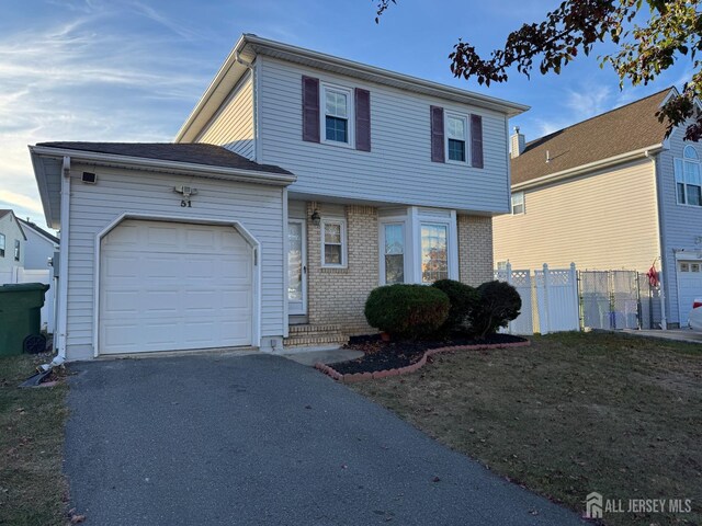 view of property with a front yard and a garage