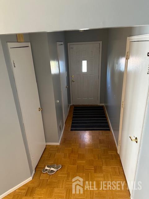 doorway with light parquet floors