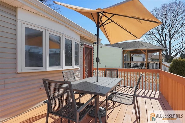 wooden terrace with outdoor dining space