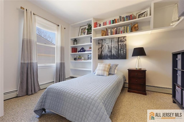 bedroom with baseboard heating and carpet flooring