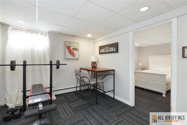 workout area with carpet, a paneled ceiling, and baseboards