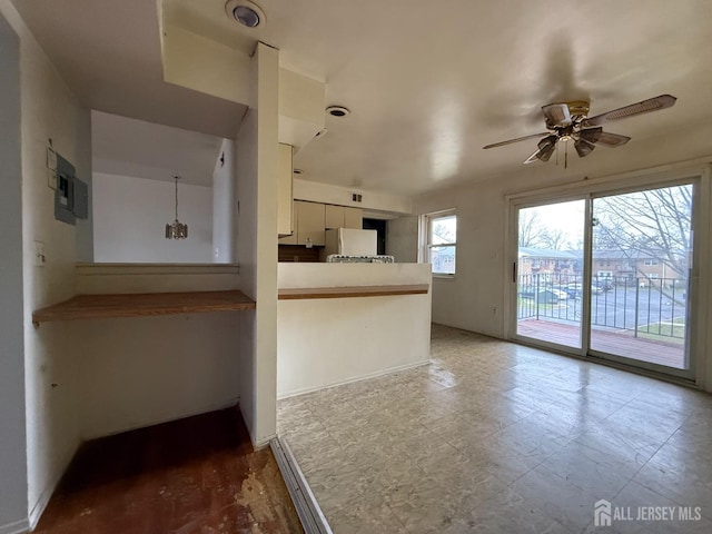 172 Evergreen Rd Unit 20B, Edison, NJ 08837 - kitchen with ceiling fan, freestanding refrigerator, white cabinets, electric panel, and a peninsula
