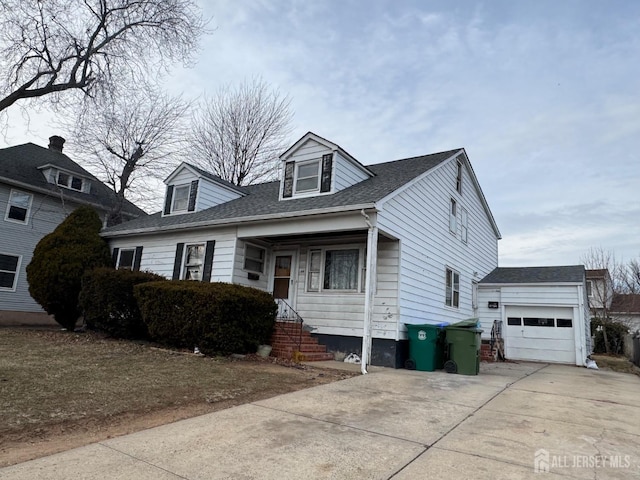 view of front of house with a garage, concrete driveway, and a shingled roof