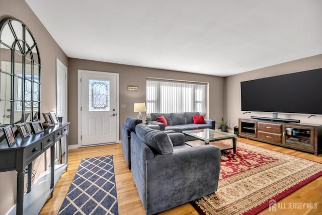 living area with light wood-style floors and baseboards