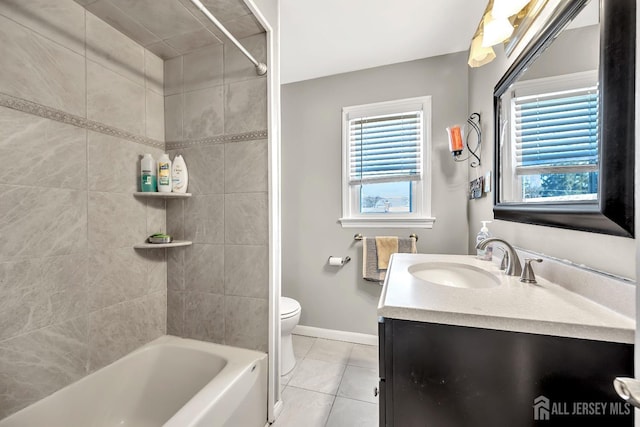 bathroom featuring a healthy amount of sunlight, vanity, baseboards, and tile patterned floors