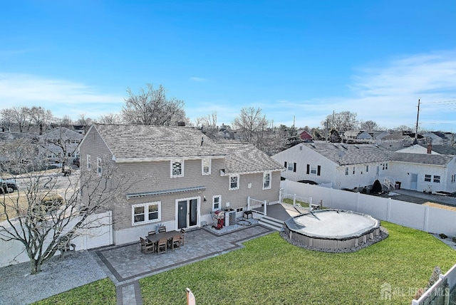 back of house with a yard, a patio area, and a fenced backyard