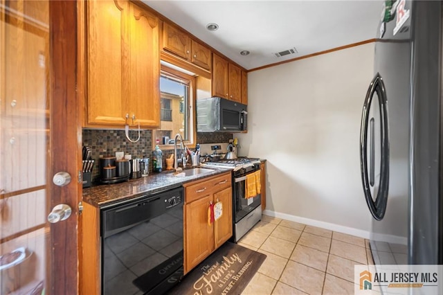156 George St, New Brunswick, NJ 08901 - kitchen featuring black appliances, backsplash, baseboards, brown cabinets, and dark stone counters