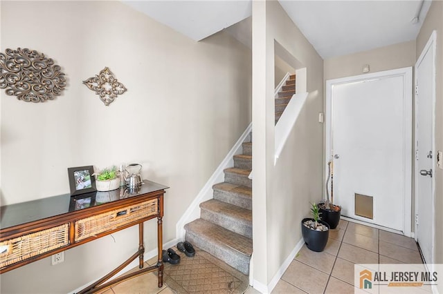156 George St, New Brunswick, NJ 08901 - stairs featuring tile patterned floors and baseboards