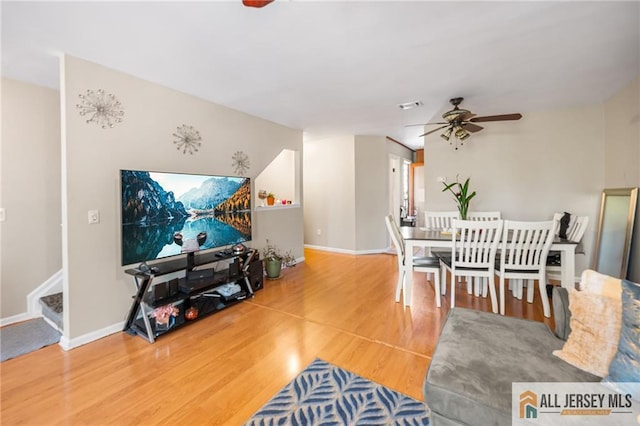 156 George St, New Brunswick, NJ 08901 - living room with ceiling fan, wood finished floors, stairway, and baseboards
