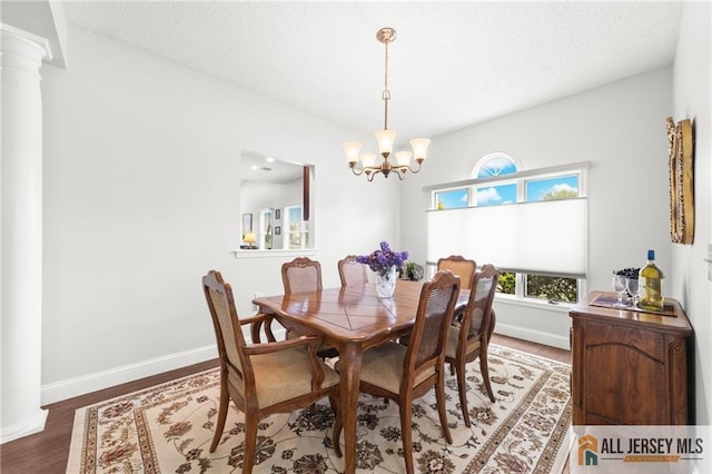 24 Birmingham Ln, Monroe, NJ 08831 - dining area featuring a chandelier, wood finished floors, ornate columns, and a textured ceiling