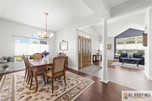 24 Birmingham Ln, Monroe, NJ 08831 - dining area featuring decorative columns, healthy amount of natural light, wood finished floors, a chandelier, and vaulted ceiling