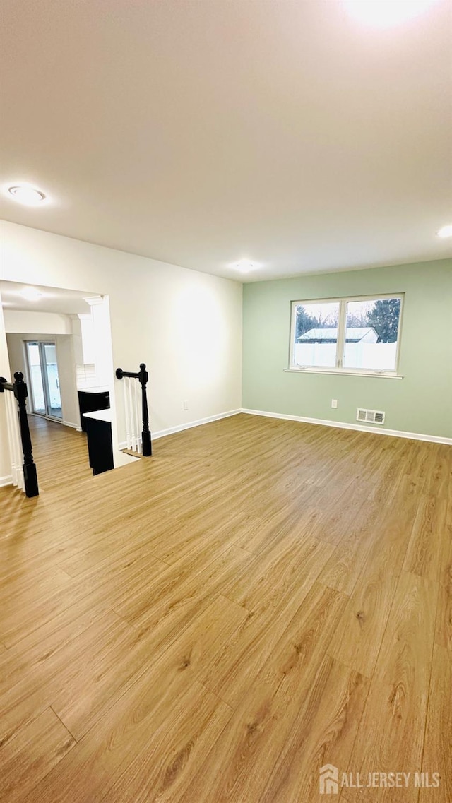 spare room with a healthy amount of sunlight and light wood-type flooring