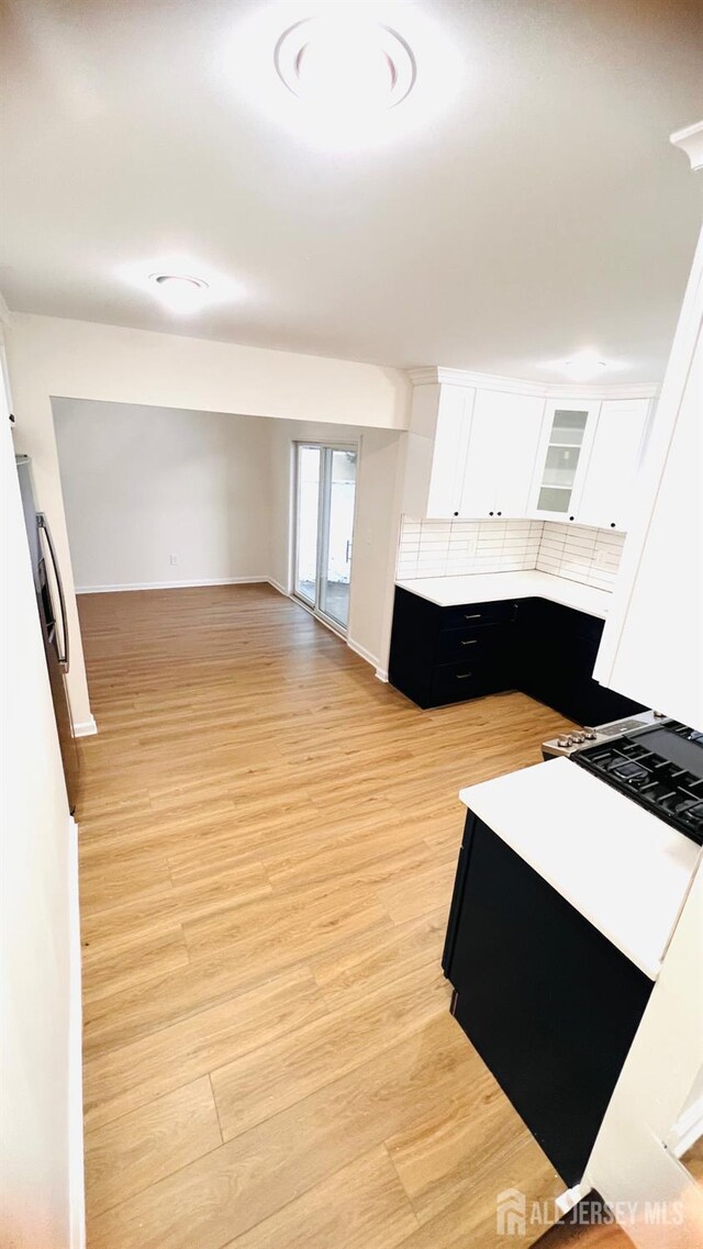 7 Harper Rd, South Brunswick, NJ 08852 - kitchen featuring white cabinetry, light countertops, dark cabinetry, and light wood-style floors
