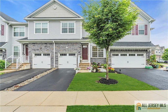 51 Begonia Ln, Monroe, NJ 08831 - townhome / multi-family property featuring asphalt driveway, a garage, stone siding, and a front yard