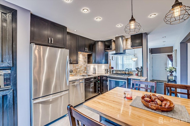 55 Renaissance Ln, New Brunswick, NJ 08901 - kitchen featuring appliances with stainless steel finishes, wall chimney exhaust hood, a sink, decorative light fixtures, and backsplash