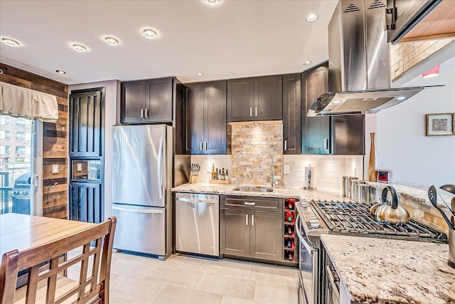 55 Renaissance Ln, New Brunswick, NJ 08901 - kitchen featuring appliances with stainless steel finishes, a sink, island exhaust hood, light stone counters, and backsplash