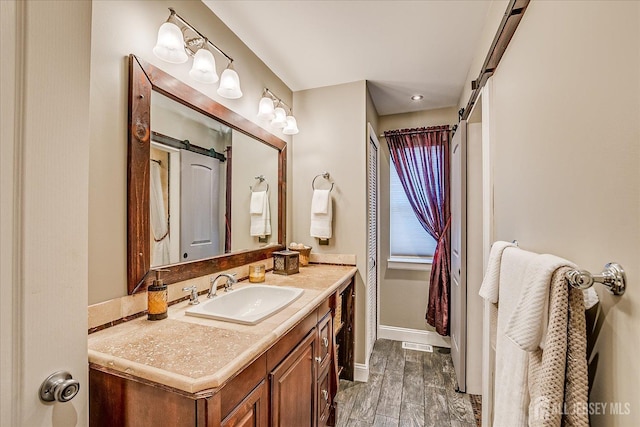 55 Renaissance Ln, New Brunswick, NJ 08901 - bathroom featuring vanity, baseboards, and wood finished floors