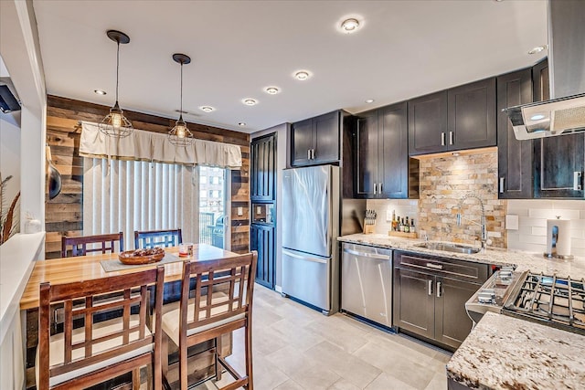 55 Renaissance Ln, New Brunswick, NJ 08901 - kitchen with stainless steel appliances, a sink, backsplash, light stone countertops, and hanging light fixtures