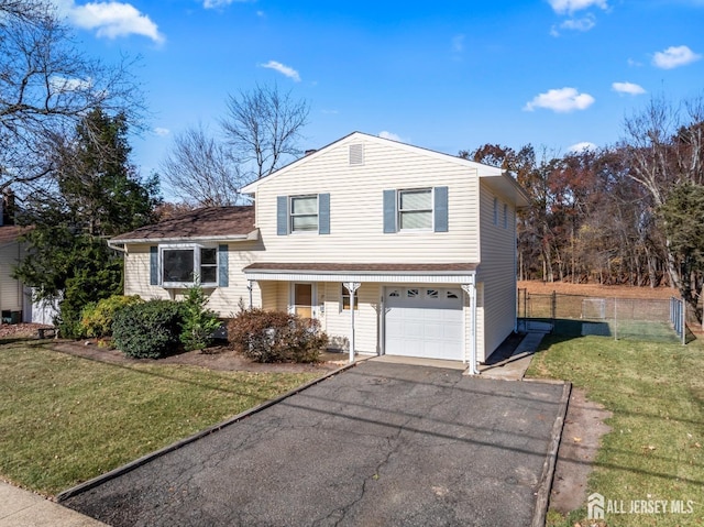 split level home featuring a front lawn and a garage