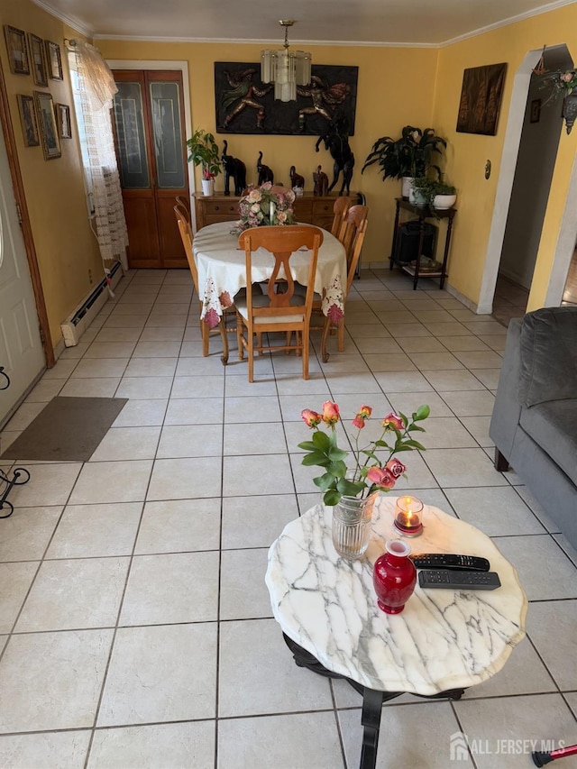 dining area featuring ornamental molding, baseboard heating, and light tile patterned flooring