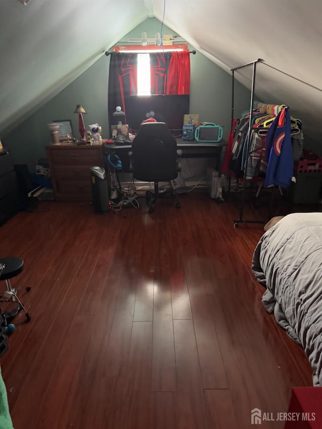 bedroom featuring vaulted ceiling and wood finished floors