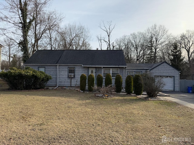 ranch-style home featuring an attached garage and a front yard