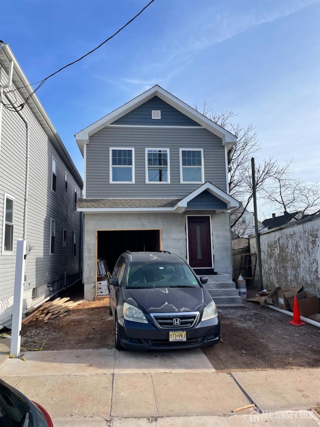 view of front facade with a garage and concrete driveway