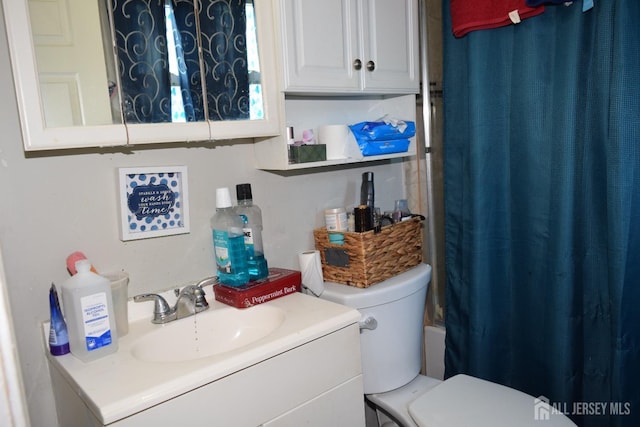 full bath with toilet and vanity