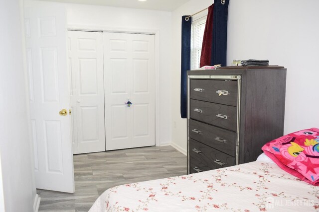 bedroom with a closet and light wood-type flooring