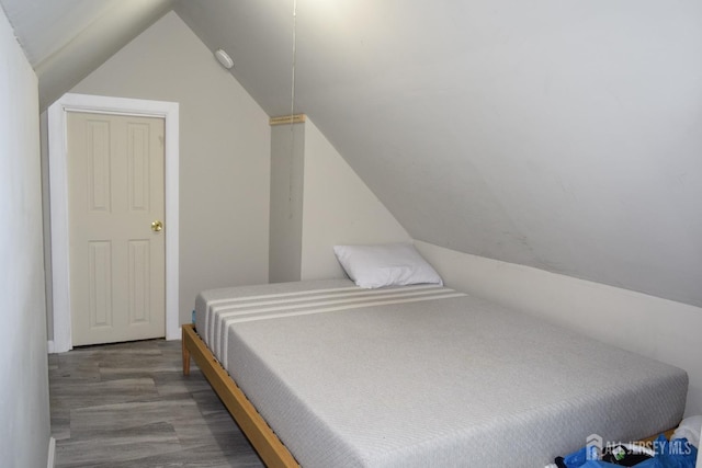 bedroom featuring vaulted ceiling and wood finished floors