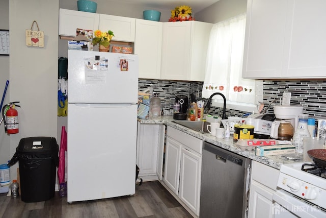 kitchen featuring light stone counters, white appliances, a sink, and white cabinetry