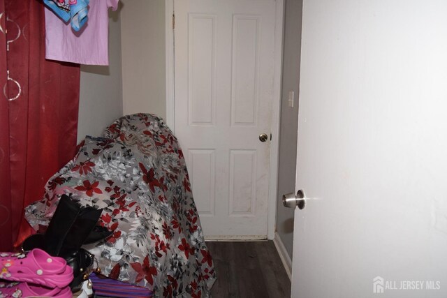 bedroom with dark wood-type flooring