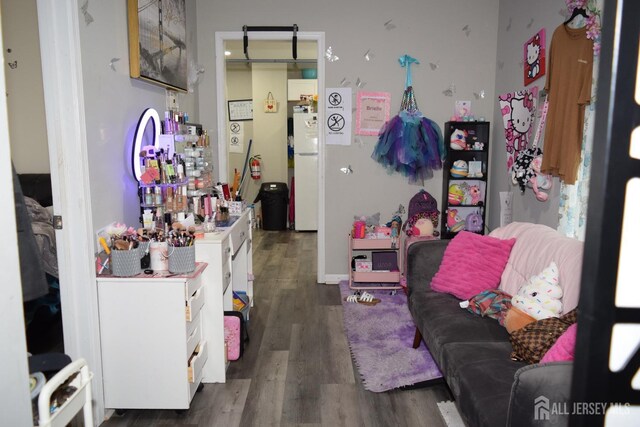 bedroom featuring white refrigerator and dark hardwood / wood-style flooring