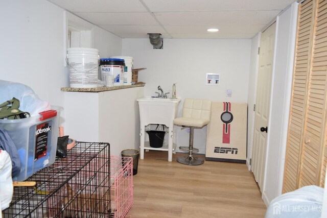 clothes washing area with hookup for a washing machine and light wood-type flooring