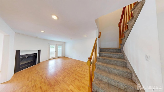 28 Elm St, East Brunswick, NJ 08816 - stairway with a glass covered fireplace, wood finished floors, and recessed lighting
