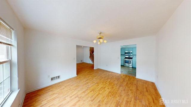 28 Elm St, East Brunswick, NJ 08816 - spare room featuring light wood-style floors and stairway