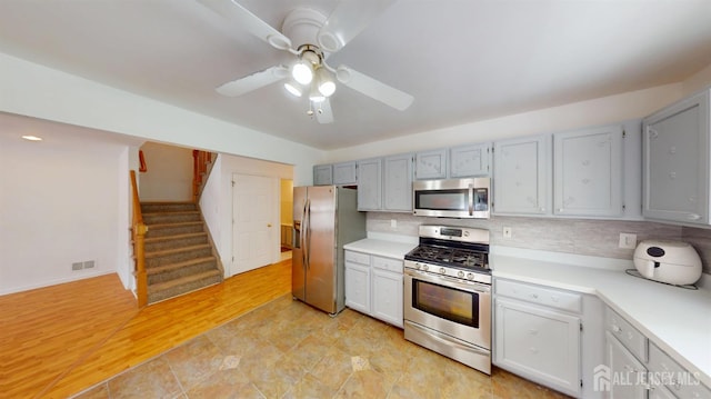 28 Elm St, East Brunswick, NJ 08816 - kitchen featuring stainless steel appliances, a ceiling fan, light countertops, and tasteful backsplash
