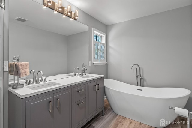 41 Haymarket Ct, East Windsor, NJ 08512 - bathroom with wood finished floors, a soaking tub, and double vanity