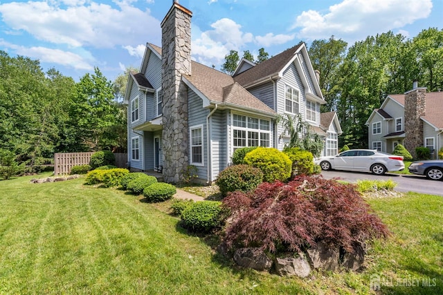 41 Haymarket Ct, East Windsor, NJ 08512 - view of side of property featuring a chimney and roof with shingles