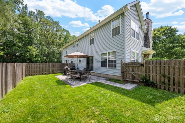 41 Haymarket Ct, East Windsor, NJ 08512 - rear view of house featuring a chimney, a fenced backyard, a patio area, and a gate